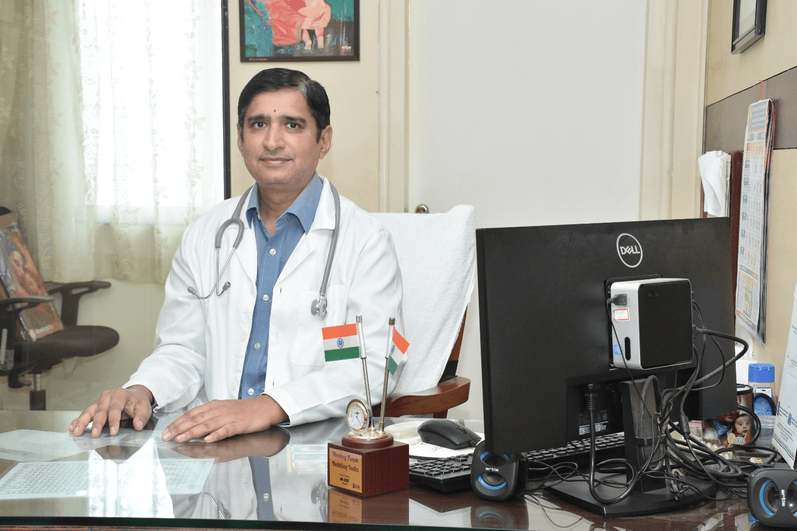 Dr. Santosh Kulkarni sitting in his clinic office